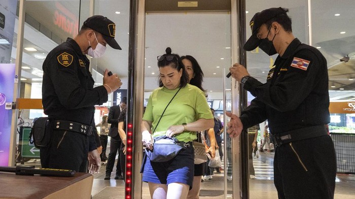 Security guards check a visitors bag before allowing them into the Siam Paragon Mall in Bangkok, Thailand, Wednesday, Oct. 4, 2023, a day after a teenage boy with a handgun opened fire inside the major shopping mall. (AP Photo/Wason Wanichakorn)