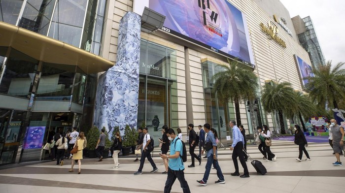 Security guards check a visitors bag before allowing them into the Siam Paragon Mall in Bangkok, Thailand, Wednesday, Oct. 4, 2023, a day after a teenage boy with a handgun opened fire inside the major shopping mall. (AP Photo/Wason Wanichakorn)