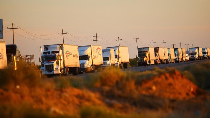 Trucks wait in a queue to cross into the United States via the Jeronimo-Santa Teresa International Bridge connecting the city of Ciudad Juarez to Santa Teresa, New Mexico, after U.S. Customs and Border Protection (CBP) set a 