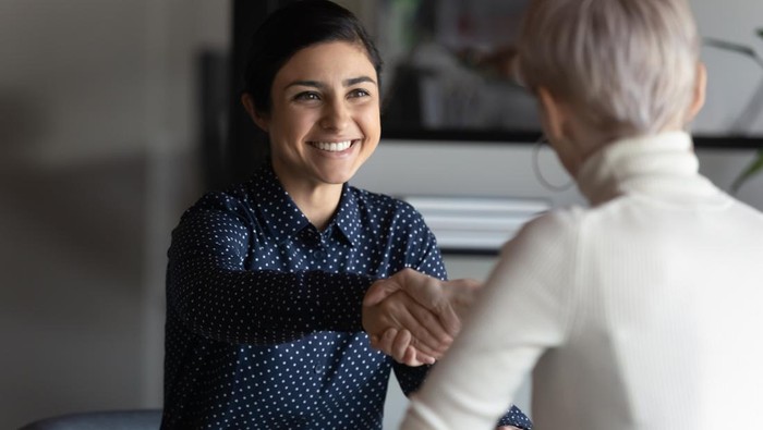 Happy employer HR manager shaking hands with indian job seeker welcoming vacancy applicant. Successful manager making deal with partner, good positive first impression, start business meeting concept