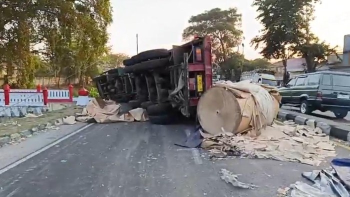 Truk tronton bermuatan kertas terguling usai menabrak truk boks di purwodadi pasuruan