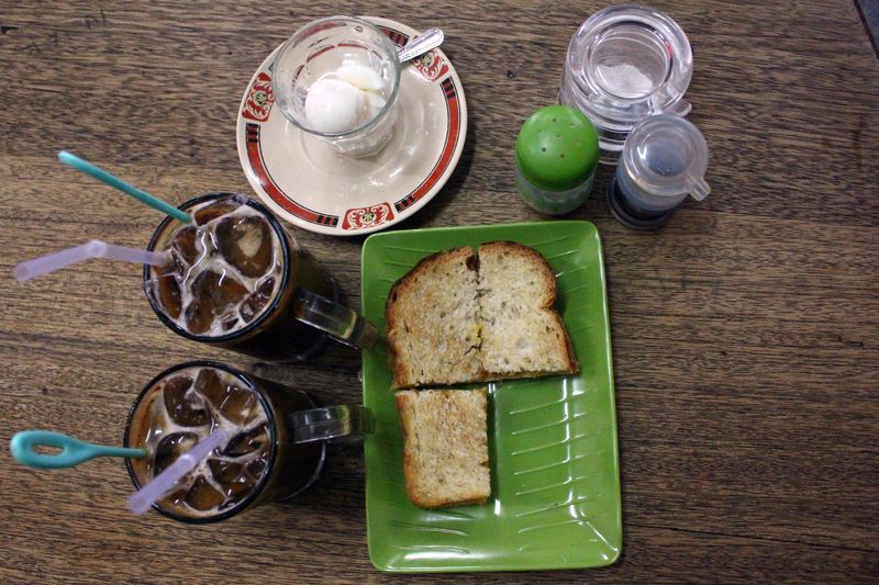 Suasana Kedai Kopi Apek di Medan, Sumatera Utara, Sabtu (07/10/2023). Kopi Apek yang berdiri sejak 1919 tersebut menjadi kedai kopi legendaris di Medan yang diminati wisatawan lokal maupun mancanegara dengan menyediakan menu andalan seperti kopi susu panas, kopi susu dingin, roti bakar, roti kukus dan puding telur. ANTARA FOTO/Yudi/foc.