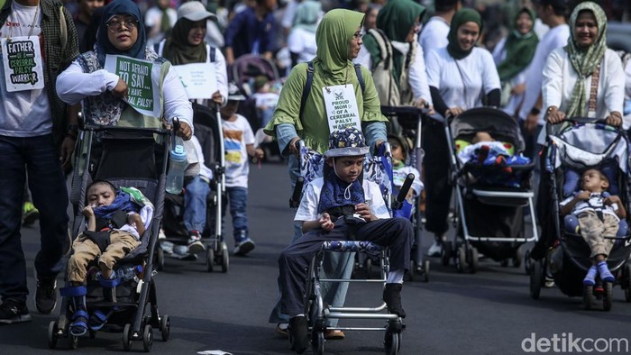 Sejumlah anak dan orangtua yang tergabung dalam Rumah Cerebral Palsy melakukan jalan santai di Bundaran HI, Jakarta, Minggu (8/10). Aksi itu untuk memperingati Hari Cerebral Palsy Sedunia.