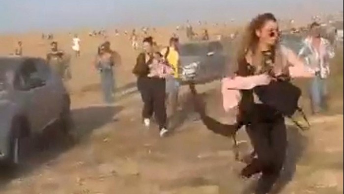 People at a dance party flee during a surprise attack launched by Hamas, near Reim, Israel October 7, 2023 in this screen grab obtained from social media video. Video obtained by Reuters/via REUTERS  THIS IMAGE HAS BEEN SUPPLIED BY A THIRD PARTY. MANDATORY CREDIT. NO RESALES. NO ARCHIVES.