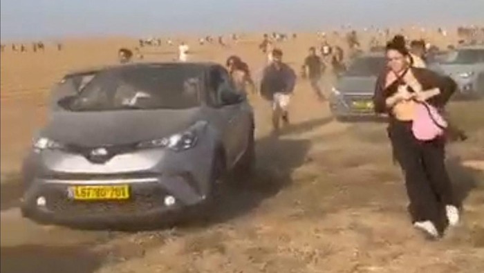 People at a dance party flee during a surprise attack launched by Hamas, near Reim, Israel October 7, 2023 in this screen grab obtained from social media video. Video obtained by Reuters/via REUTERS  THIS IMAGE HAS BEEN SUPPLIED BY A THIRD PARTY. MANDATORY CREDIT. NO RESALES. NO ARCHIVES.
