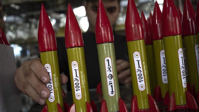 Belal Abu Saraya arranges perfume containers representing rockets used against Israel in a perfume store against Israel in past conflicts at his shop in Gaza City on Thursday, Oct. 5, 2023. AP Photo/Fatima Shbair)