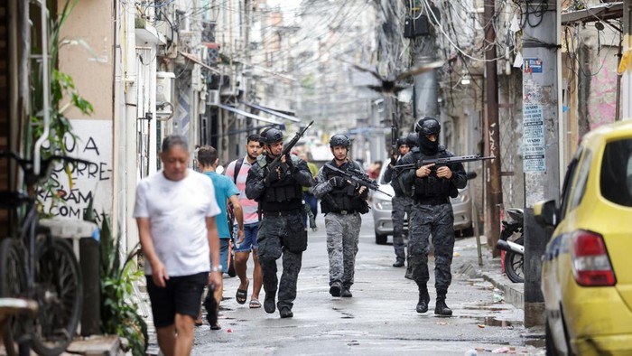 Police officers stand on a bulldozer, during an anti-crime operation inside the favelas Mare complex, in Rio de Janeiro, Brazil, October 9, 2023. REUTERS/Pilar Olivares     TPX IMAGES OF THE DAY