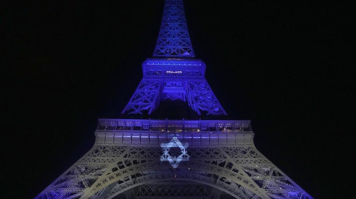 The Eiffel Tower is illuminated with the colors of Israel after a demonstration in a show of support for Israel, Monday, Oct. 9, 2023 in Paris, two days after Hamas fighters launched an unprecedented, multi-front attack on Israel which killed more than 700 people. (AP Photo/Michel Euler)