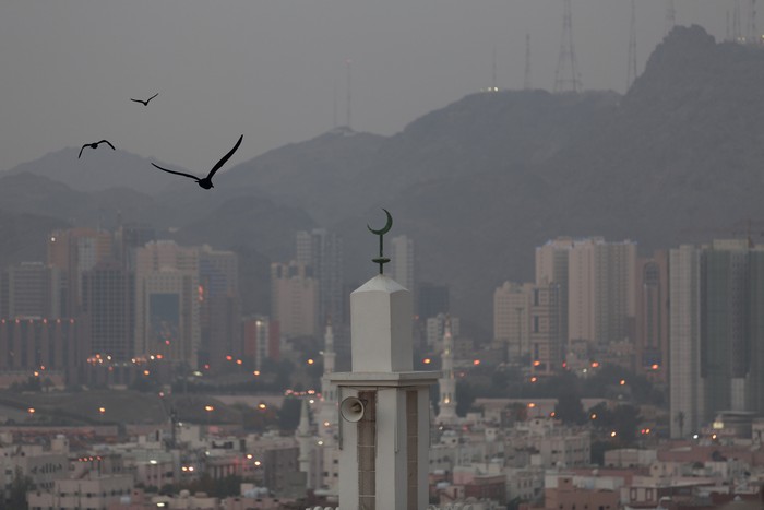 Birds flying around the minaret in Mecca
