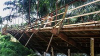 Warga bergantungan di besi saat melewati jembatan gantung yang terputus di Desa Alue Keujruen, Kecamatan Tanah Luas, Aceh Utara, Aceh. Selasa (10/10/2023).  