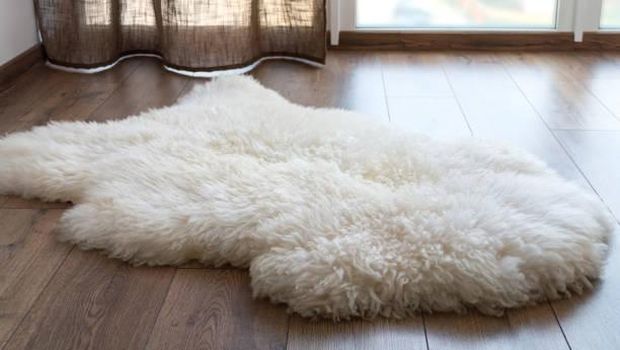 Sheep skin on the laminate floor in the room. Cozy place near the window