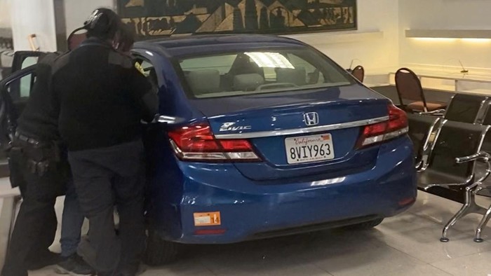 People evacuate as security personnel respond to the driver of a car which crashed into the Chinese consulate in San Francisco, California, U.S. October 9, 2023 in this screen grab obtained from social media video. Sergii/via REUTERS  THIS IMAGE HAS BEEN SUPPLIED BY A THIRD PARTY. MANDATORY CREDIT. NO RESALES. NO ARCHIVES.