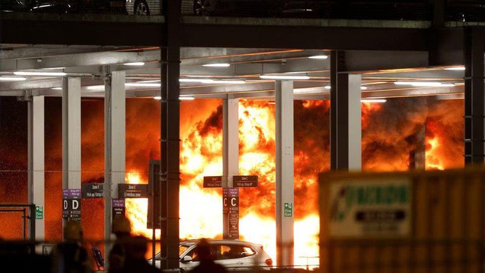 Flames are seen as emergency services respond to a fire in Terminal Car Park 2 at London Luton airport in Luton, Britain, October 10, 2023. REUTERS/Peter Cziborra Acquire Licensing Rights