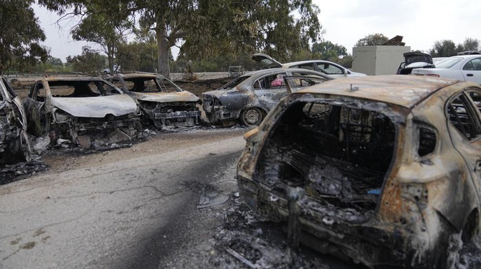 Destroyed cars are seen at the rave party site near the Kibbutz Re'im, close to the Gaza Strip border fence, on Tuesday, Oct.10, 2023. Israel's rescue service Zaka said paramedics had recovered at least 260 bodies of people killed in a surprise attack by Hamas militants Saturday. (AP Photo/Ohad Zwigenberg)