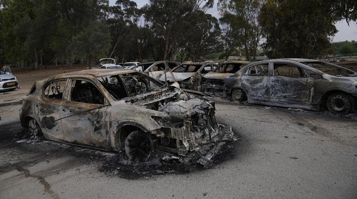 Destroyed cars are seen at the rave party site near the Kibbutz Re'im, close to the Gaza Strip border fence, on Tuesday, Oct.10, 2023. Israel's rescue service Zaka said paramedics had recovered at least 260 bodies of people killed in a surprise attack by Hamas militants Saturday. (AP Photo/Ohad Zwigenberg)