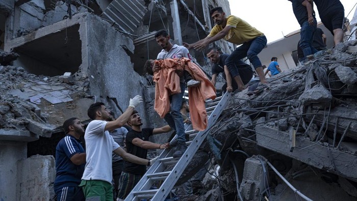 A relative mourns over a girl killed in an Israeli air strike in Gaza City on Monday, Oct. 9, 2023. Israels military battled to drive Hamas fighters out of southern towns and seal its borders Monday as it pounded the Gaza Strip. (AP Photo/Fatima Shbair)