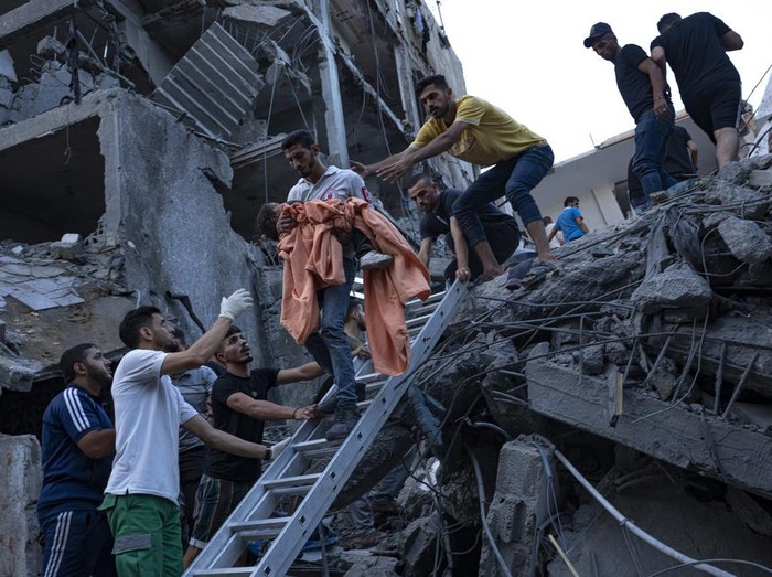 A relative mourns over a girl killed in an Israeli air strike in Gaza City on Monday, Oct. 9, 2023. Israels military battled to drive Hamas fighters out of southern towns and seal its borders Monday as it pounded the Gaza Strip. (AP Photo/Fatima Shbair)