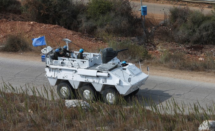 United Nations peacekeepers (UNIFIL) stand near their vehicles in Kfar Kila village near the border with Israel, southern Lebanon, October 8, 2023. REUTERS/Aziz Taher