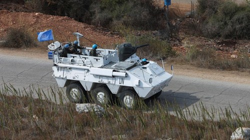 United Nations peacekeepers (UNIFIL) stand near their vehicles in Kfar Kila village near the border with Israel, southern Lebanon, October 8, 2023. REUTERS/Aziz Taher