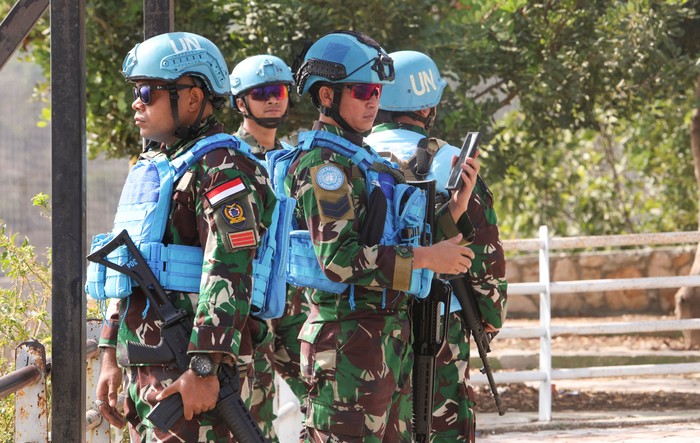 United Nations peacekeepers (UNIFIL) stand near their vehicles in Kfar Kila village near the border with Israel, southern Lebanon, October 8, 2023. REUTERS/Aziz Taher