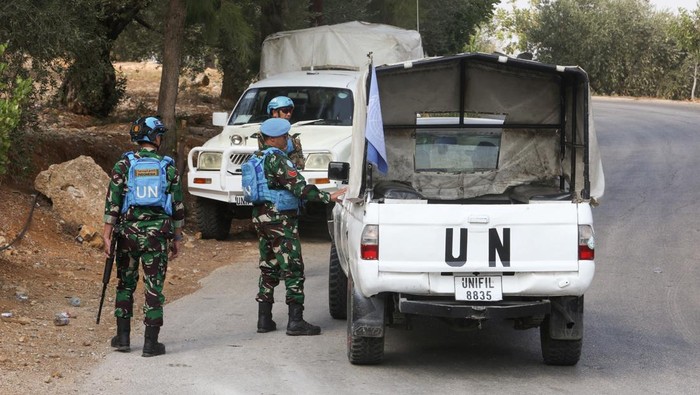 United Nations peacekeepers (UNIFIL) stand near their vehicles in Kfar Kila village near the border with Israel, southern Lebanon, October 8, 2023. REUTERS/Aziz Taher