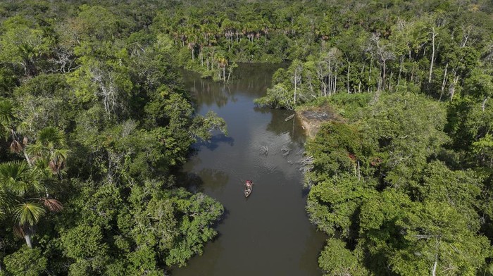 Indigenous ride a boat on the Komi Memem River, named Laje in non-Indigenous maps, at the Wari' Indigenous community in Guajara-Mirim, Rondonia state, Brazil, Thursday, July 13, 2023. The Amazon city of Guajara-Mirim recently approved a law that designates the Laje River 