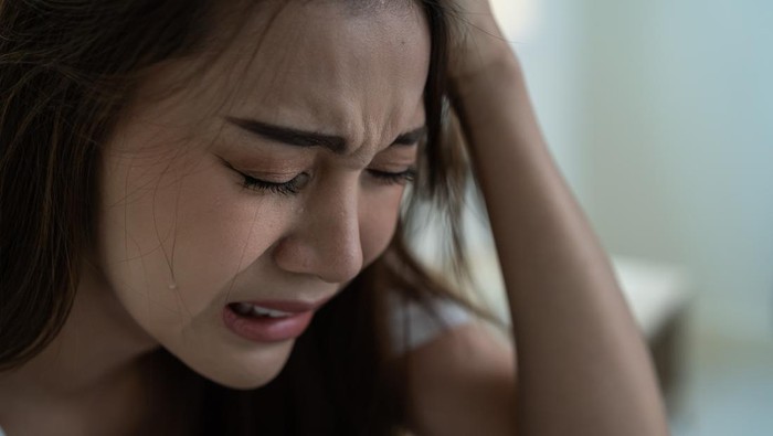 Woman, stress and depression in lonely mental health problems, issues or anxiety at home. Sad female face suffering from loneliness, withdrawal or abuse with depressed emotion alone in the bedroom