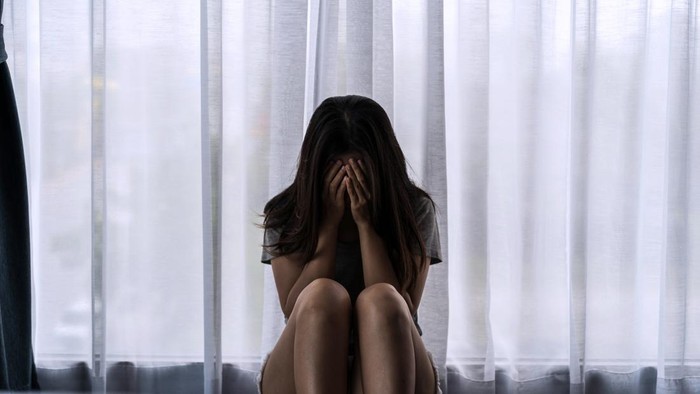 Lonely young woman feeling depressed and stressed sitting in the dark bedroom, Negative emotion and mental health concept