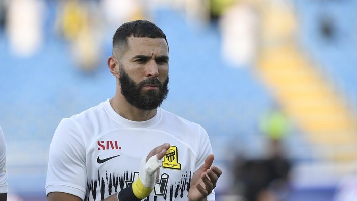 Al Ittihads Karim Benzema greets fans during his team match against Al Raed in the Saudi Professional League, in Buraidah, Saudi Arabia, Monday, Aug. 14, 2023. (AP Photo)