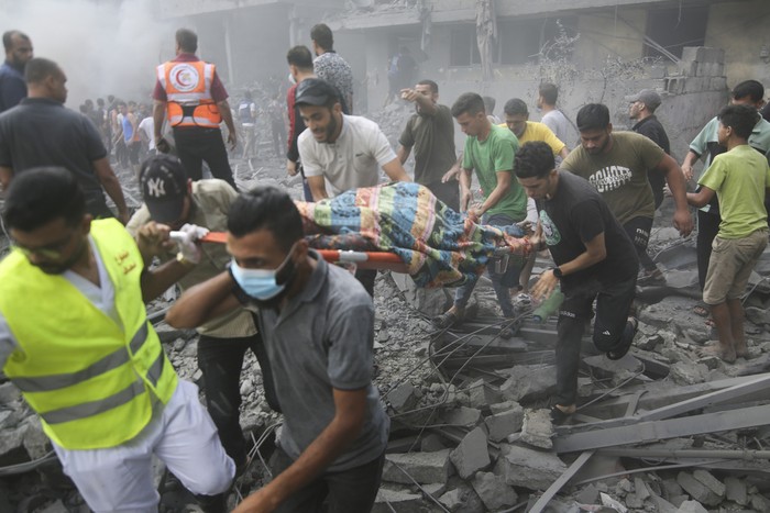 Palestinians evacuate wounded after an Israeli airstrike in Rafah refugee camp, southern Gaza Strip, Thursday, Oct. 12, 2023. (AP Photo/Hatem Ali)