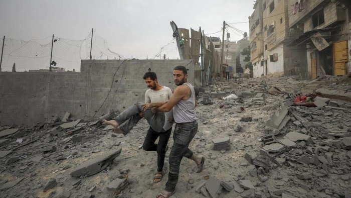 Palestinians evacuate wounded in Israeli aerial bombing on Jabaliya, near Gaza City, Wednesday, Oct.11, 2023 (AP Photo/Mohammad Al Masri)