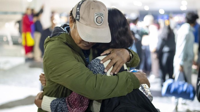 A Nepalese woman welcomes her daughter who is evacuated from Israel at the Tribhuvan International Airport in Kathmandu, Nepal, Friday, Oct. 13, 2023. More than 200 Nepali nationals evacuated by the government returned home Friday as the government worked to bring back the bodies of 10 Nepali students who were killed by the Hamas militant attack in Israel. (AP Photo/Niranjan Shrestha)