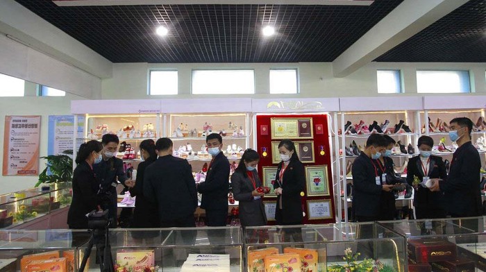 Visitors check shoes as the 2022 Autumn National Footwear Exhibition opened at Pyongyang Yokjon Department Store in Pyongyang, on Tuesday, Oct., 18, 2022. (AP Photo/Cha Song Ho)