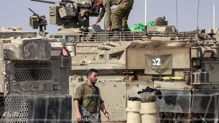 ISRAEL-PALESTINIAN-GAZA-CONFLICT Israeli army Namer armoured personnel carriers (APCs) deploys with others along the border with the Gaza Strip in southern Israel on October 13, 2023. Thousands of people, both Israeli and Palestinians have died since October 7, 2023, after Palestinian Hamas militants entered Israel in a surprise attack leading Israel to declare war on Hamas in the Gaza Strip enclave on October 8. (Photo by Menahem KAHANA / AFP)