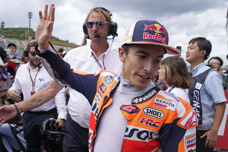 Spanish rider Marc Marquez waves to fans after the MotoGP qualification session for Sunday's Japanese Motorcycle Grand Prix at the Twin Ring Motegi circuit in Motegi, north of Tokyo Saturday Sept. 30, 2023. Honda's MotoGP team says that former world champion Marc Márquez will be leaving the team at the end of the season. That will conclude a highly successful 11-year-stint during which the Spaniards won six MotoGP championships. (AP Photo/Shuji Kajiyama)