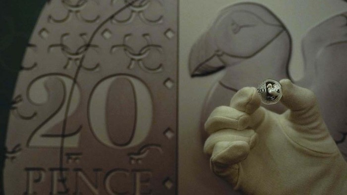 The Royal Mint unveils new coins for use in the United Kingdom, they use UK flora and fauna as images on the reverse side, a detail showing the new 20 pence coin, the Puffin motif on display during a media preview in London, Thursday, Oct. 12, 2023. (AP Photo/Alastair Grant)