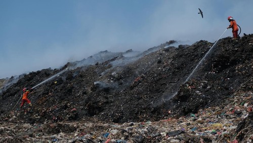 Sebuah bak berisi air yang dicampur eco enzyme disiapkan untuk memadamkan api kebakaran sampah di Tempat Pembuangan Akhir (TPA) Regional Sarbagita Suwung, Denpasar, Bali, Senin (16/10/2023). Kebakaran yang terjadi pada Kamis (12/10) tersebut hingga saat ini belum padam sehingga tim gabungan masih melakukan penanganan melalui operasi darat, udara dan penanganan dengan cara injeksi yang mengerahkan 16 unit mobil pemadam kebakaran, enam unit mobil tangki air untuk menyuplai air bagi pemadam. dan dua unit helikopter BNPB. ANTARA FOTO/Nyoman Hendra Wibowo/tom.