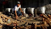 Relawan memasak dengan kayu bakar untuk menyediakan makanan bagi warga Palestina yang meninggalkan rumah mereka di tengah serangan Israel di Khan Younis, di selatan Jalur Gaza, Minggu (15/10/2023).