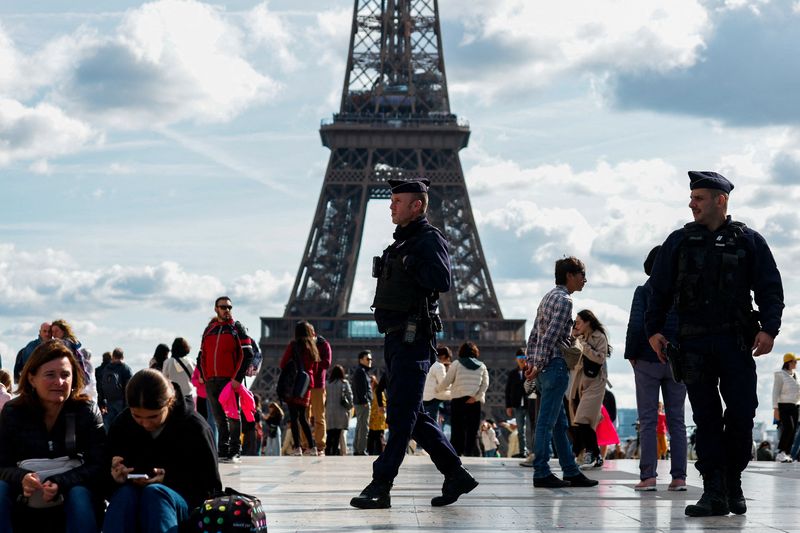 French police patrol at the Trocadero Square near the Eiffel Tower in Paris as French government puts nation on its highest state of alert after a deadly knife attack in northern France, October 15, 2023. REUTERS/Gonzalo Fuentes     TPX IMAGES OF THE DAY