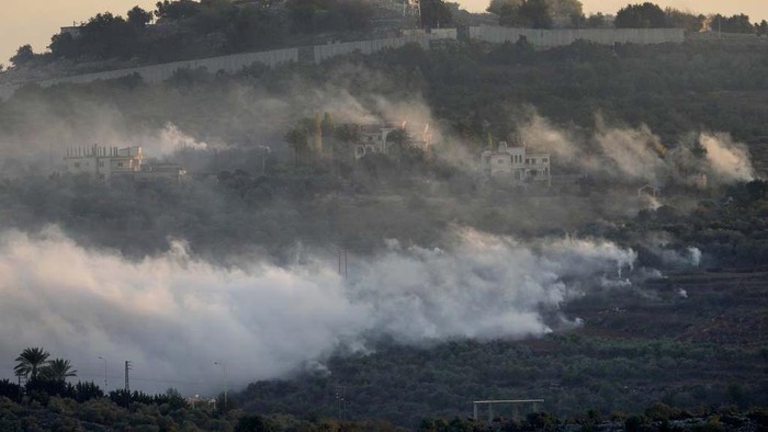 Smoke rises from Israeli artillery shelling in Dahaira, a Lebanese border village with Israel, south Lebanon, Monday, Oct. 16, 2023. Lebanons militant Hezbollah group says its fighters have targeted an Israeli position along the border directly hitting a Merkava tank. (AP Photo/Hussein Malla)