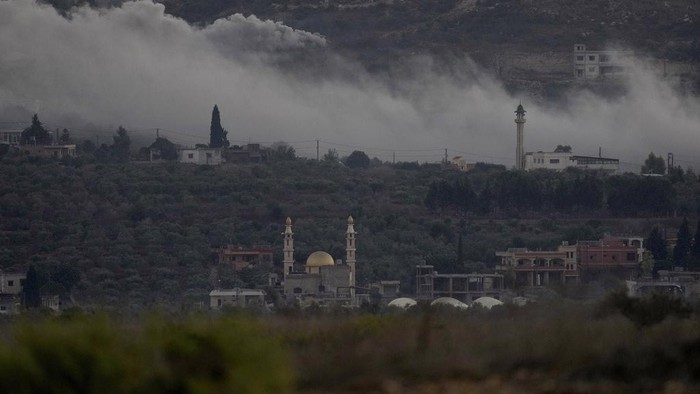 Smoke rises from Israeli artillery shelling in Dahaira, a Lebanese border village with Israel, south Lebanon, Monday, Oct. 16, 2023. Lebanons militant Hezbollah group says its fighters have targeted an Israeli position along the border directly hitting a Merkava tank. (AP Photo/Hussein Malla)