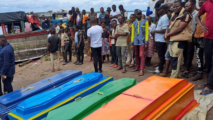 People stand among the belongings of the passengers of the boat capsized on the Congo river in Mbandaka, Democratic Republic of Congo October 16, 2023. REUTERES/Stringer NO RESALES. NO ARCHIVES