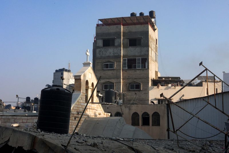 Women react at the Greek Orthodox Saint Porphyrius Church which was damaged by an Israeli strike, where Palestinians who fled their homes take shelter, in Gaza City, October 20, 2023. REUTERS/Mohammed Al-Masri