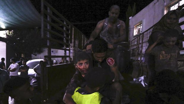 Wounded Palestinians arrive at the al-Shifa hospital, on a truck, following Israeli airstrikes on Gaza City, central Gaza Strip, Thursday, Oct. 19, 2023. (AP Photo/Abed Khaled)