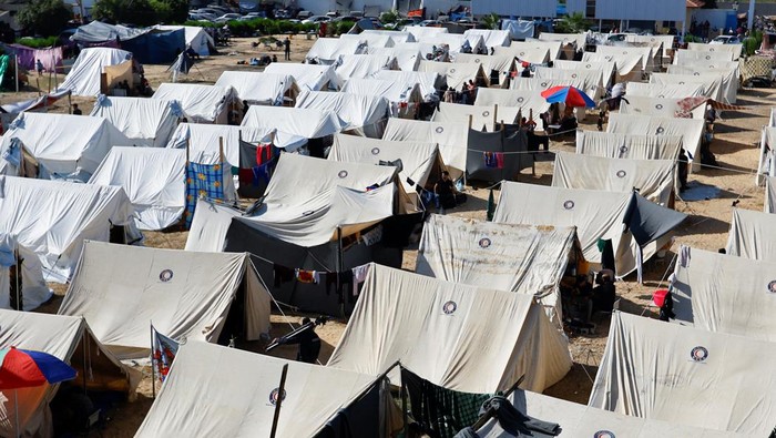 Palestinians, who fled their houses amid Israeli strikes, take shelter in a tent camp at a United Nations-run centre, after Israel's call for more than 1 million civilians in northern Gaza to move south, in Khan Younis in the southern Gaza Strip, October 19, 2023. REUTERS/Ibraheem Abu Mustafa
