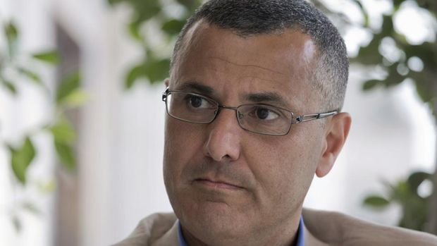 Omar Barghouti listens during an interview with the Associated Press in the West Bank city of Ramallah, Tuesday, May 10, 2016. Barghouti, a Qatari-born Palestinian who is married to an Israeli woman and leader of the international boycott movement against Israel, on Tuesday accused Israeli authorities of imposing a travel ban on him as retribution for his political activities.  (AP Photo/Nasser Nasser)