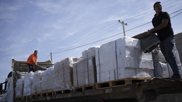 Trucks with humanitarian aid for the Gaza Strip enter from Egypt in Rafah on Saturday, Oct. 21, 2023. (AP Photo/Fatima Shbair)