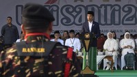 Presiden Joko Widodo (tengah) disaksikan Ibu Negara Iriana Joko Widodo (kedua kanan), Ketua PBNU KH Yahya Cholil Staquf (keempat kanan), Rais Aam PBNU KH Miftachul Akhyar (ketiga kiri) serta Gubernur Jawa Timur Khofifah Indar Parawansa (kanan) berpidato ketika memimpin apel Hari Santri Nasional di Tugu Pahlawan, Surabaya, Jawa Timur, Minggu (22/10/2023). 