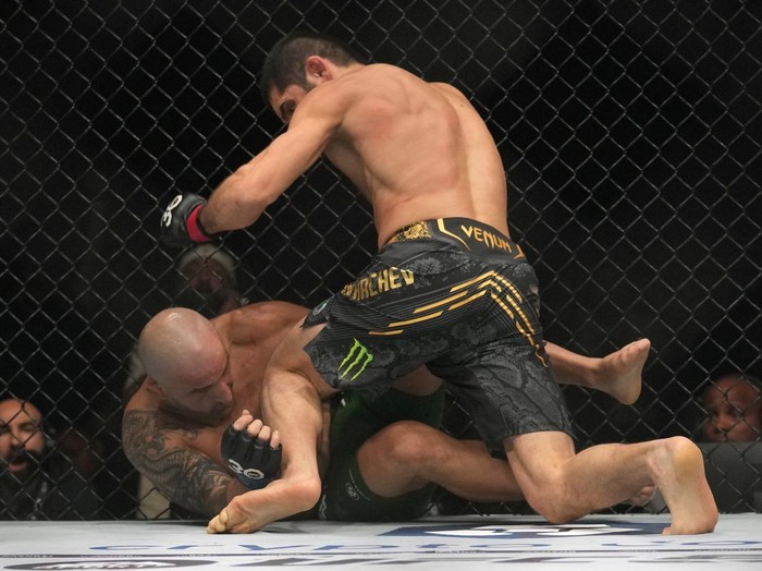 Islam Makhachev of Russia, on top, battles Alex Volkanovski of Australia in the UFC lightweight championship fight during UFC 294, mixed martial arts fights at the Ethihad Arena in Abu Dhabi, United Arab Emirates, Saturday, Oct. 21, 2023. (AP Photo/Kamran Jebreili)