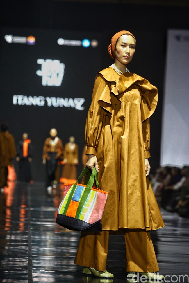 Fashion show koleksi ready to wear Itang Yunasz yang didesain putrinya Najla Kamila, di gelaran Jakarta Muslim Fashion Week 2024, ICE BSD, Tangerang. Koleksi ini menghadirkan modest wear nuansa cokelat dan oranye. Foto: Ari Saputra
